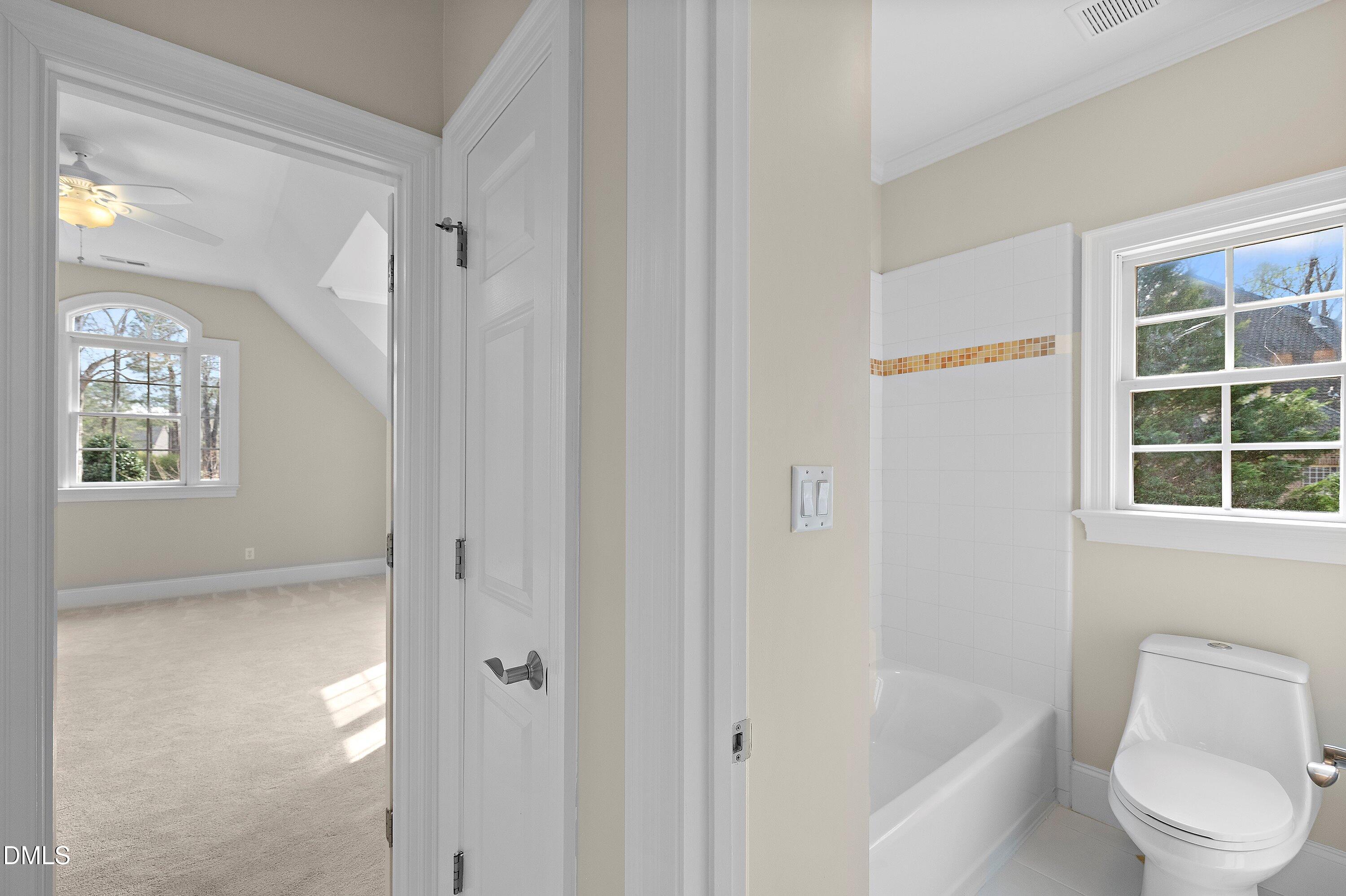 1525 Eglantyne Court Raleigh, NC 27613 - Photo 58 of 105 a bathroom with a toilet tub and window