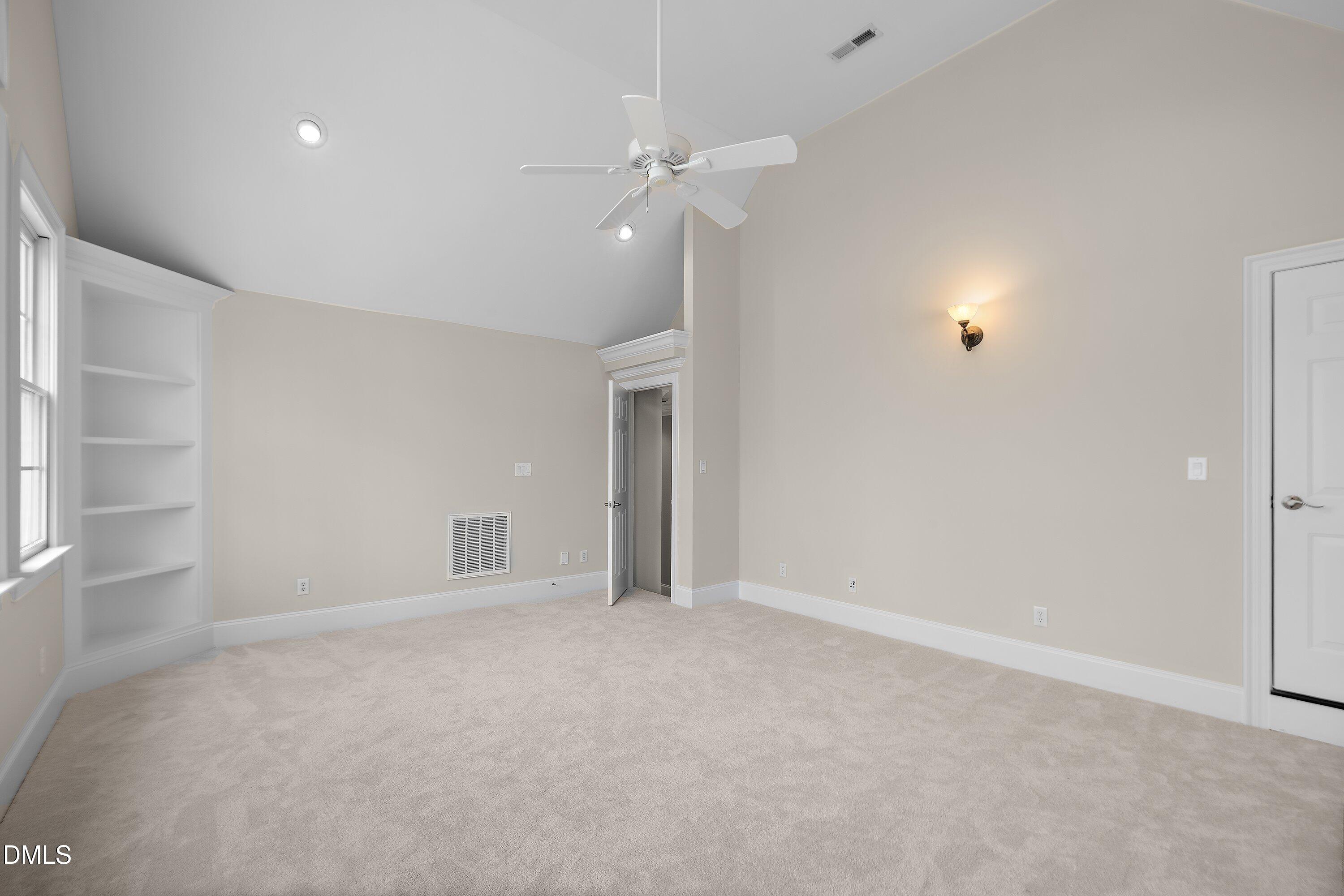 1525 Eglantyne Court Raleigh, NC 27613 - Photo 62 of 105 a view of an empty room with a ceiling fan