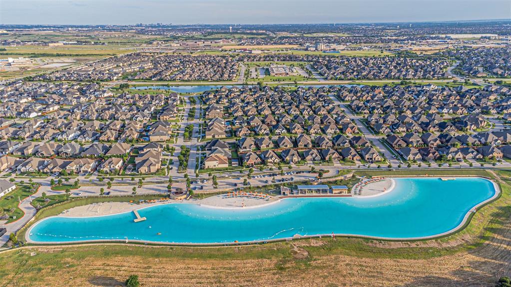 1070 Adair Road Prosper, TX 75078 - Photo 36 of 40 Expansive neighborhood featuring numerous residential properties and a large, blue-water lagoon
