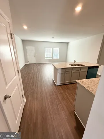 wooden floor with kitchen view