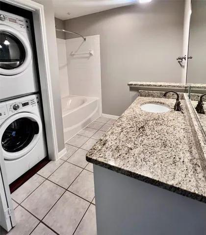 a bathroom with a sink a mirror and bathtub