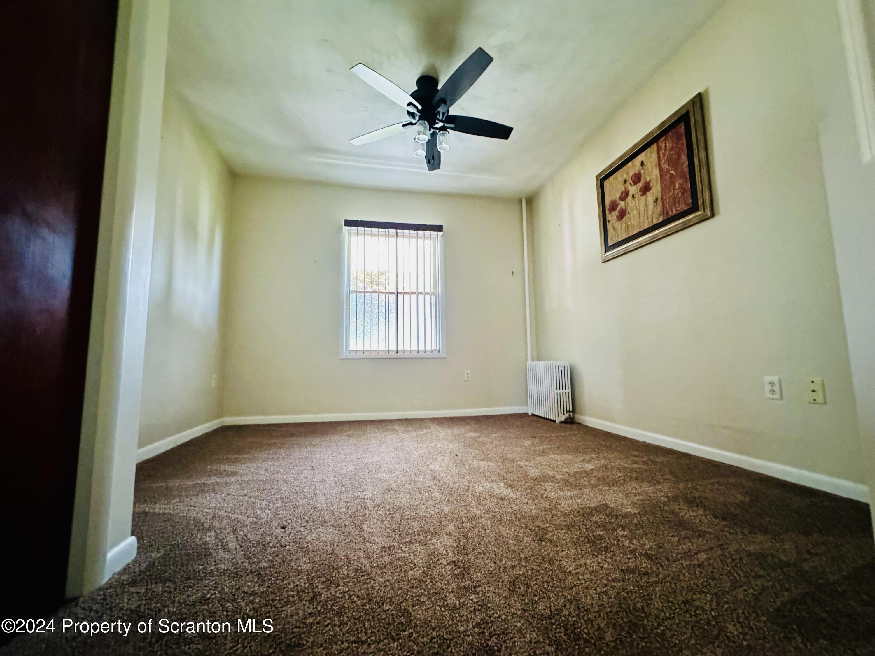631 Cherry Street Scranton, PA 18505 - Photo 11 of 17 an empty room with windows and fan