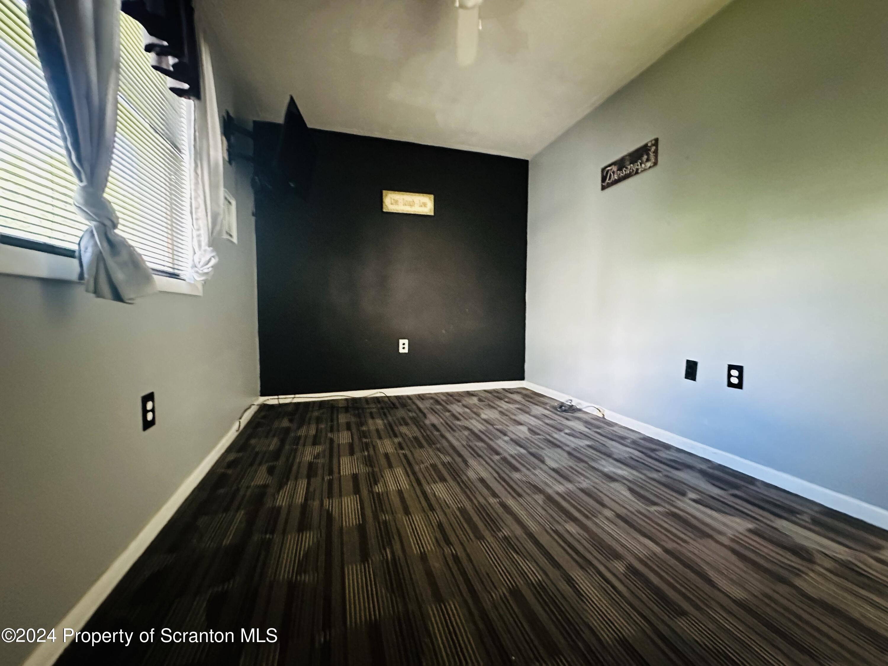 631 Cherry Street Scranton, PA 18505 - Photo 13 of 17 a view of a big room with wooden floor