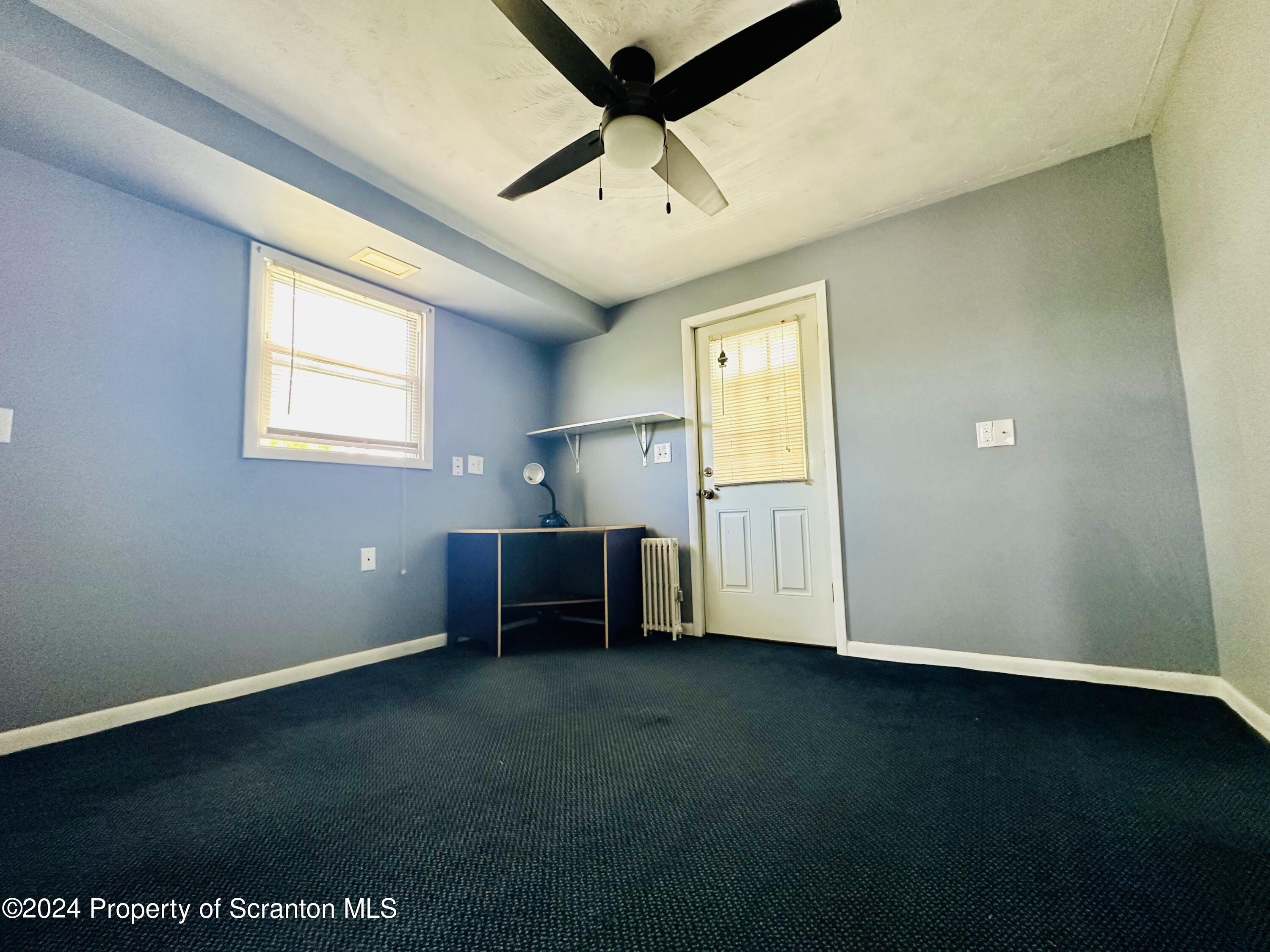 631 Cherry Street Scranton, PA 18505 - Photo 14 of 17 an empty room with windows and cabinet