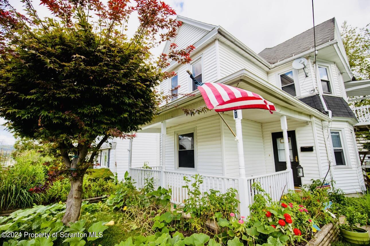 631 Cherry Street Scranton, PA 18505 - Photo 2 of 17 a view of a house with a flower garden