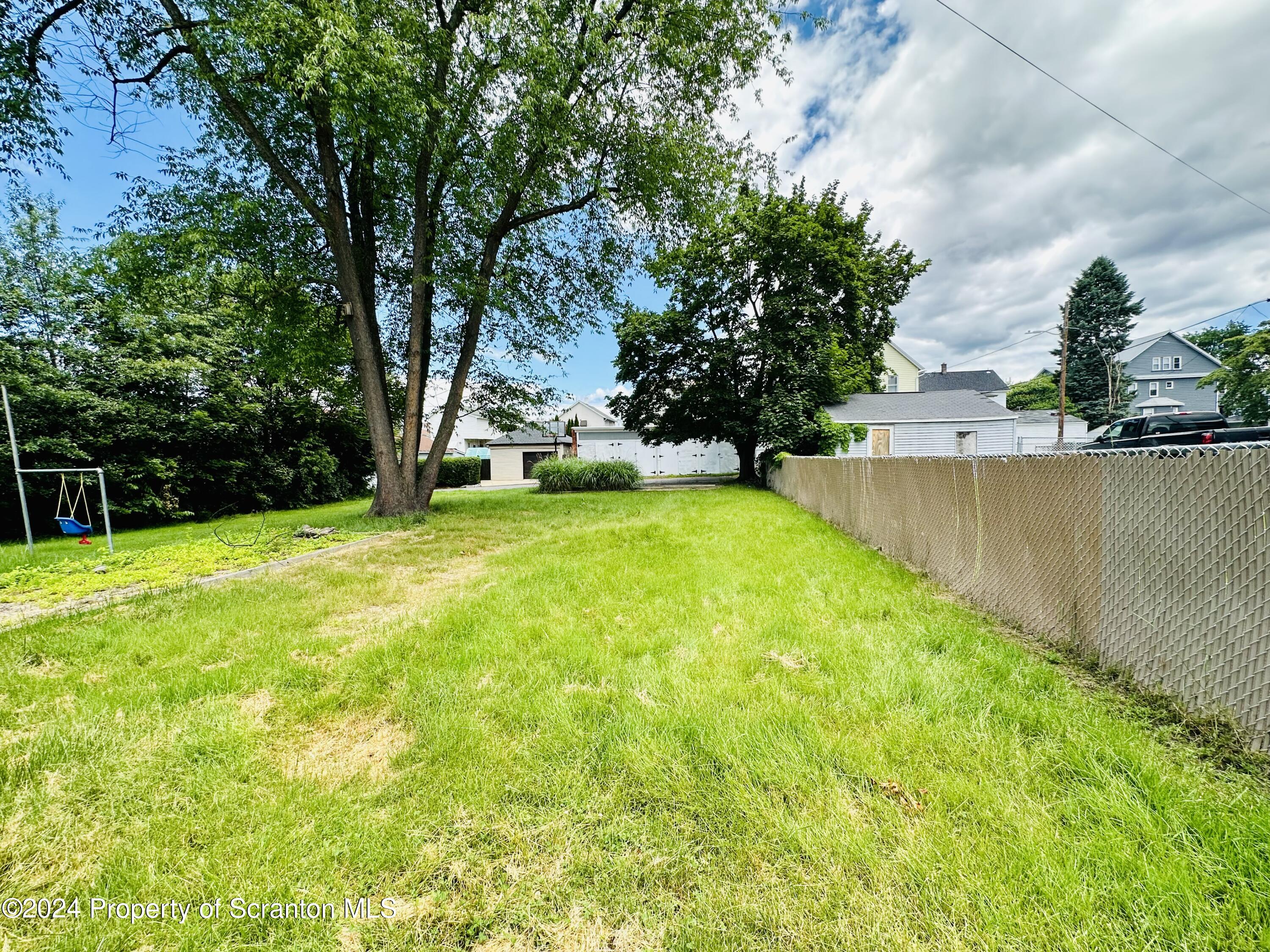 631 Cherry Street Scranton, PA 18505 - Photo 6 of 17 a view of a swimming pool and trees in the background