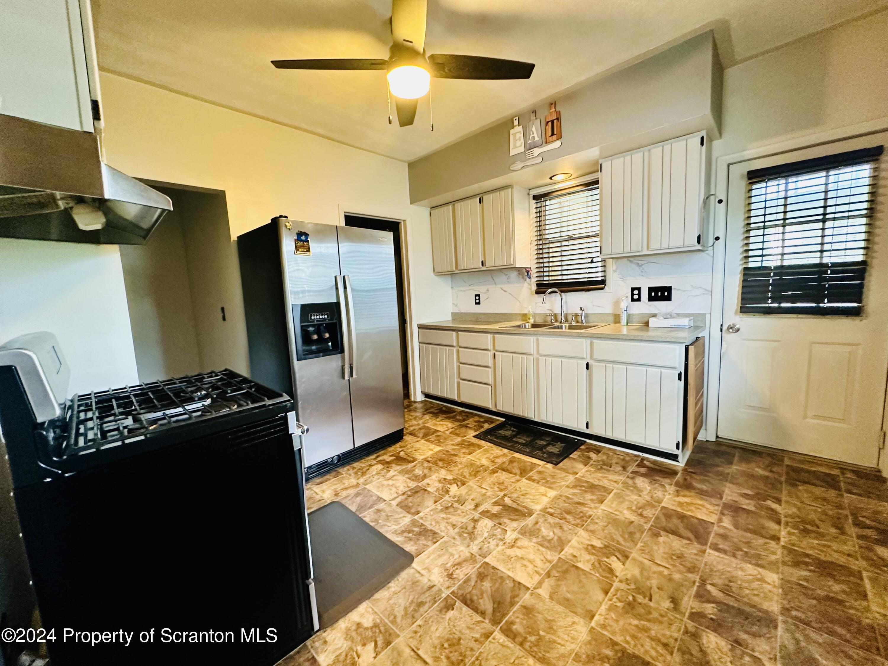 631 Cherry Street Scranton, PA 18505 - Photo 8 of 17 a kitchen with stainless steel appliances granite countertop a refrigerator and a stove