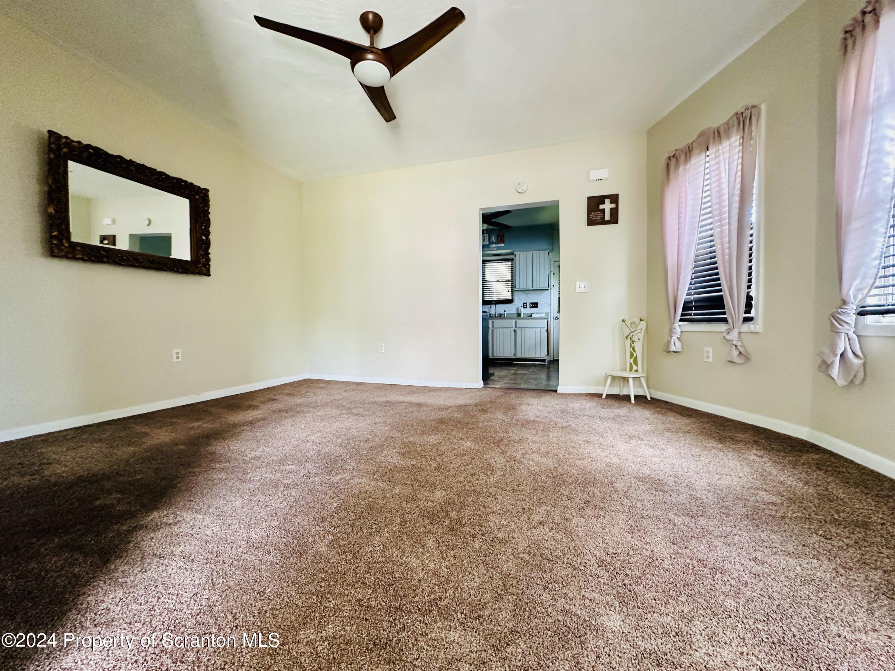 631 Cherry Street Scranton, PA 18505 - Photo 10 of 17 a view of a livingroom with a ceiling fan and window
