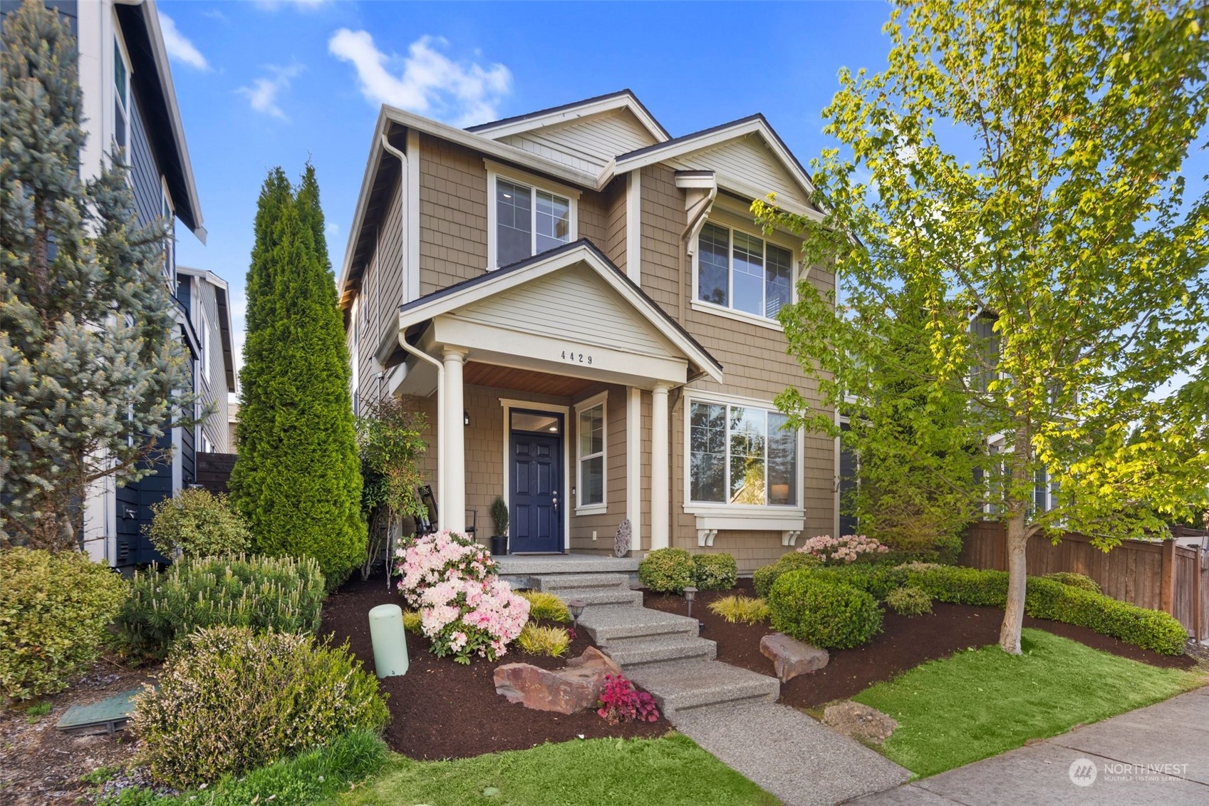 4429 186th Place Southeast Bothell, WA 98012 - Photo 1 of 37 a front view of a house with a yard and potted plants