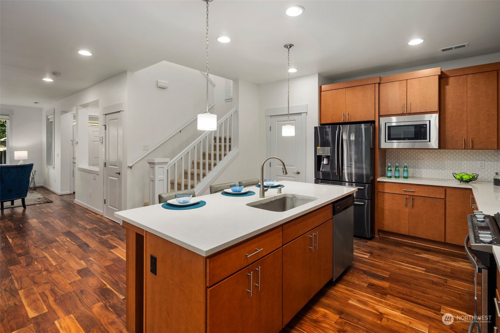 4429 186th Place Southeast Bothell, WA 98012 - Photo 13 of 37 a kitchen with stainless steel appliances kitchen island granite countertop a sink and a refrigerator