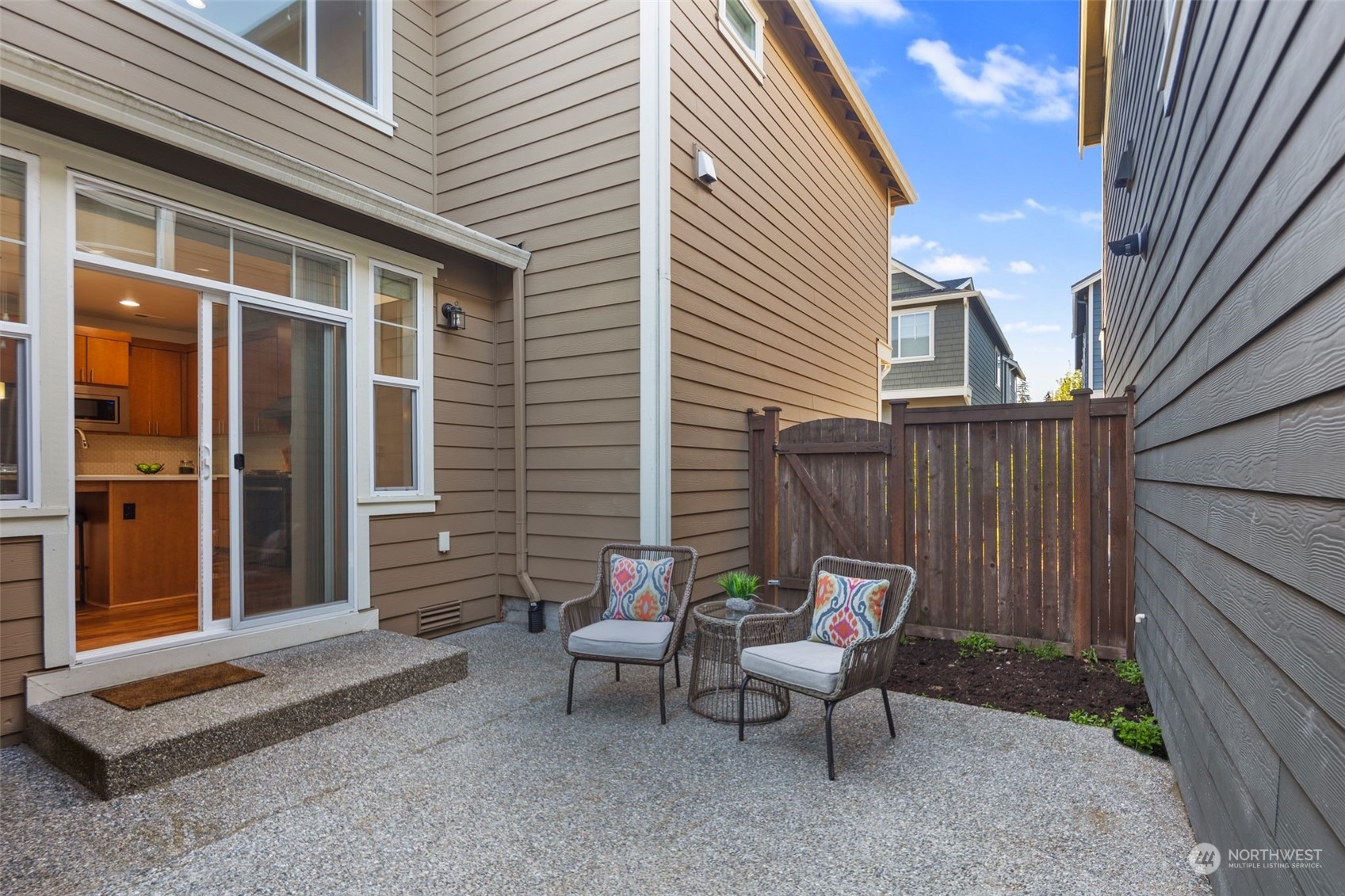 4429 186th Place Southeast Bothell, WA 98012 - Photo 15 of 37 a view of a patio with a table and chairs and wooden fence