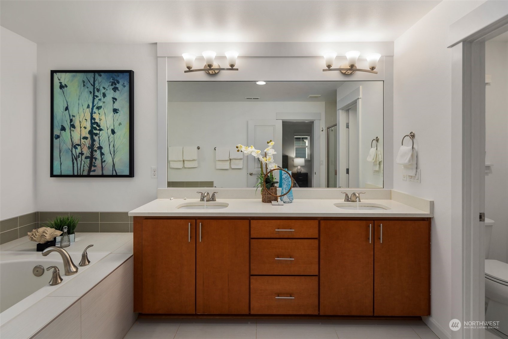4429 186th Place Southeast Bothell, WA 98012 - Photo 24 of 37 a en suite bathroom with double sink a large mirror and a bathtub