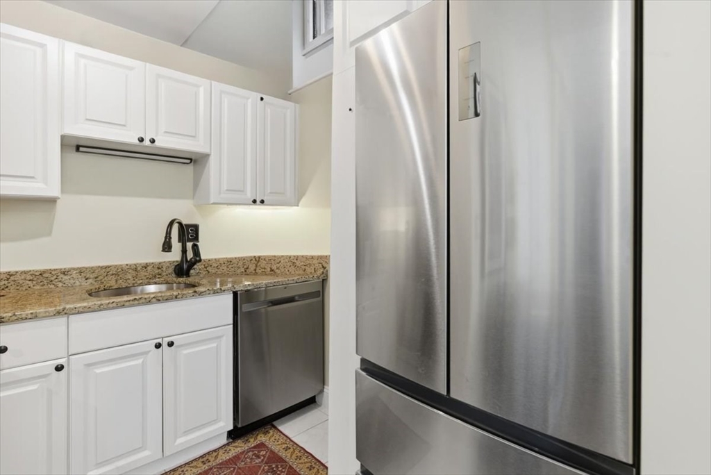 65 Glen Road, Unit H1 Brookline, MA 02445 - Photo 15 of 39 a kitchen with stainless steel appliances granite countertop white cabinets and a refrigerator