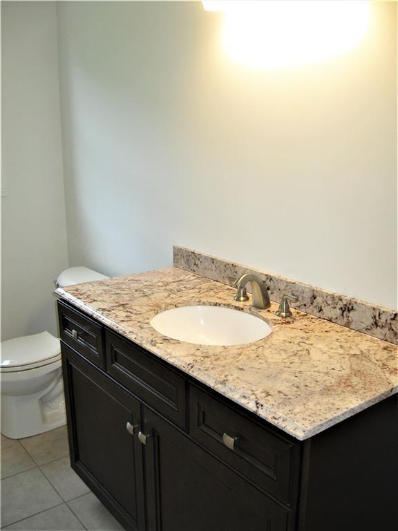 3903 Zimmerly Road Erie, PA 16506 - Photo 20 of 25 a bathroom with a granite countertop sink and toilet