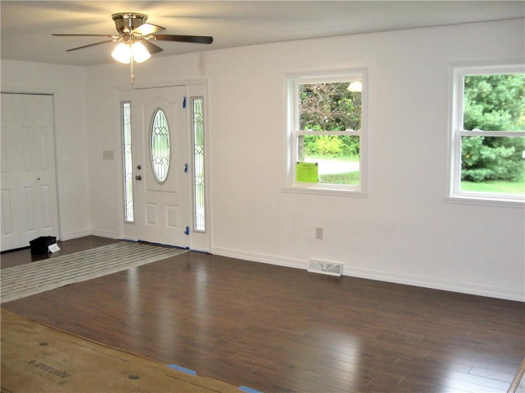 3903 Zimmerly Road Erie, PA 16506 - Photo 5 of 25 an empty room with wooden floor fan and windows