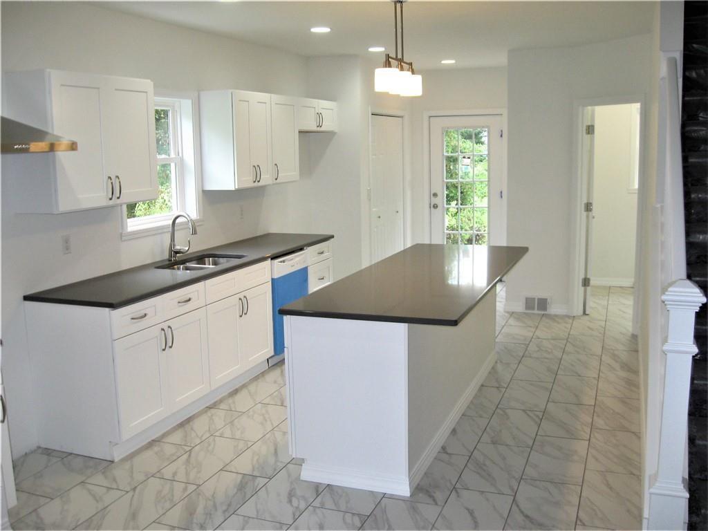 3903 Zimmerly Road Erie, PA 16506 - Photo 9 of 25 a kitchen with stainless steel appliances granite countertop a sink a counter space and cabinets