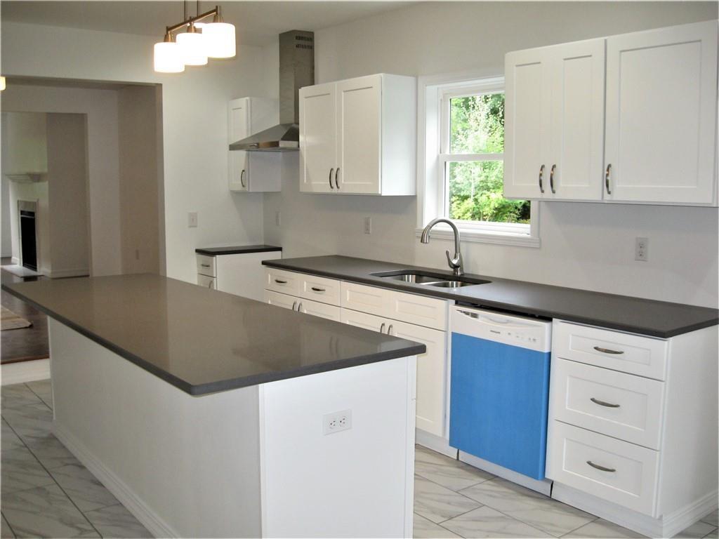 3903 Zimmerly Road Erie, PA 16506 - Photo 10 of 25 a kitchen with granite countertop a sink and a stove