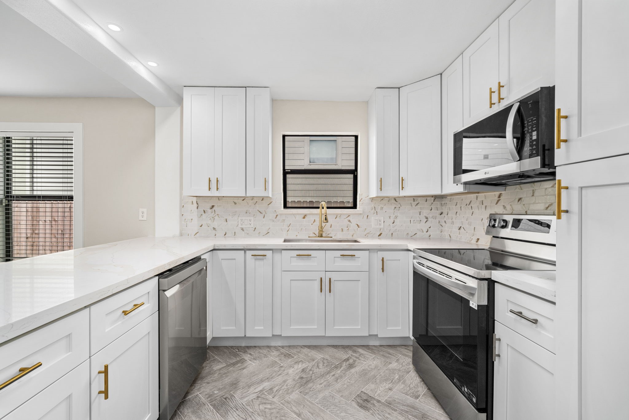 803 East 29th Street Houston, TX 77009 - Photo 12 of 28 a kitchen with white cabinets appliances and a window