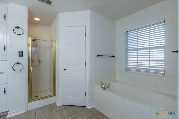 a bathroom with a bathtub and a shower