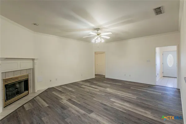 wooden floor in an empty room with a fireplace