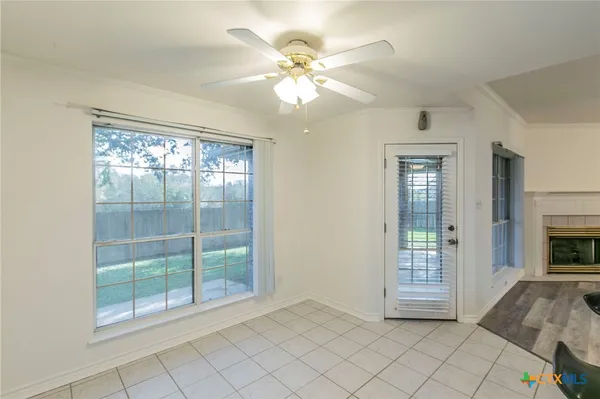 a view of an empty room with glass door