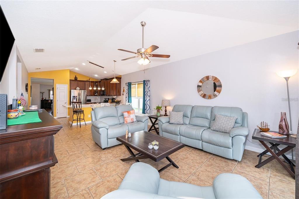 3406 Brant Street St. Cloud, FL 34772 - Photo 17 of 33 a living room with furniture kitchen view and a chandelier