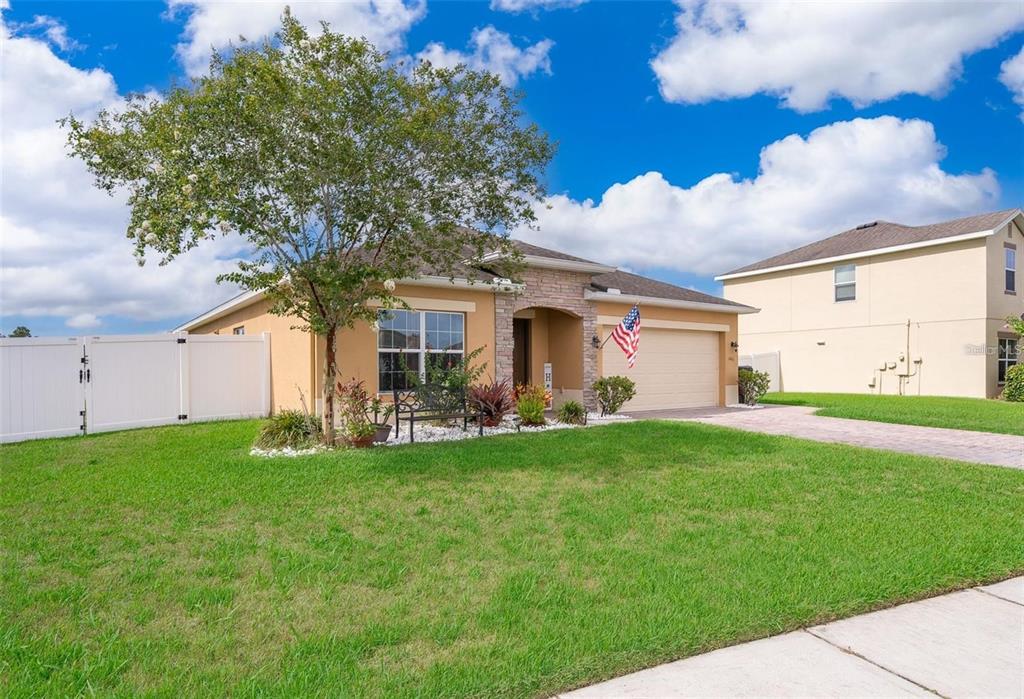 3406 Brant Street St. Cloud, FL 34772 - Photo 2 of 33 a front view of a house with patio and garden