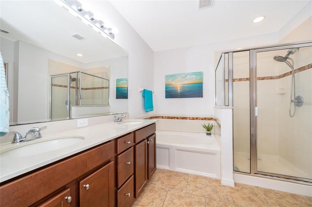 3406 Brant Street St. Cloud, FL 34772 - Photo 22 of 33 a bathroom with a tub a sink and mirror