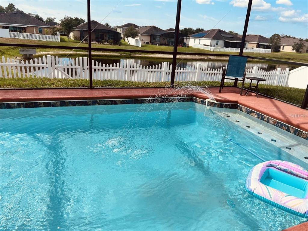 3406 Brant Street St. Cloud, FL 34772 - Photo 28 of 33 a view of a swimming pool with a yard and wooden deck
