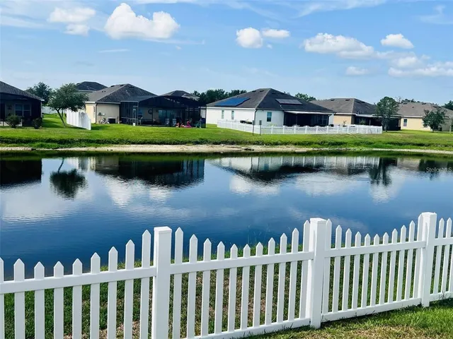 a view of a lake with houses in the back