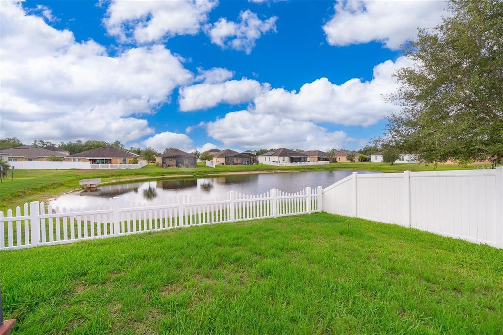 3406 Brant Street St. Cloud, FL 34772 - Photo 31 of 33 a view of a lake with a big yard and large trees