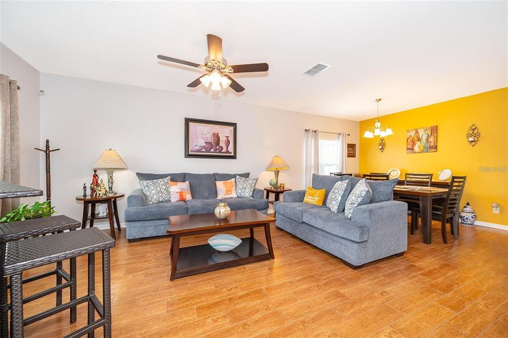 3406 Brant Street St. Cloud, FL 34772 - Photo 7 of 33 a living room with furniture and a wooden floor