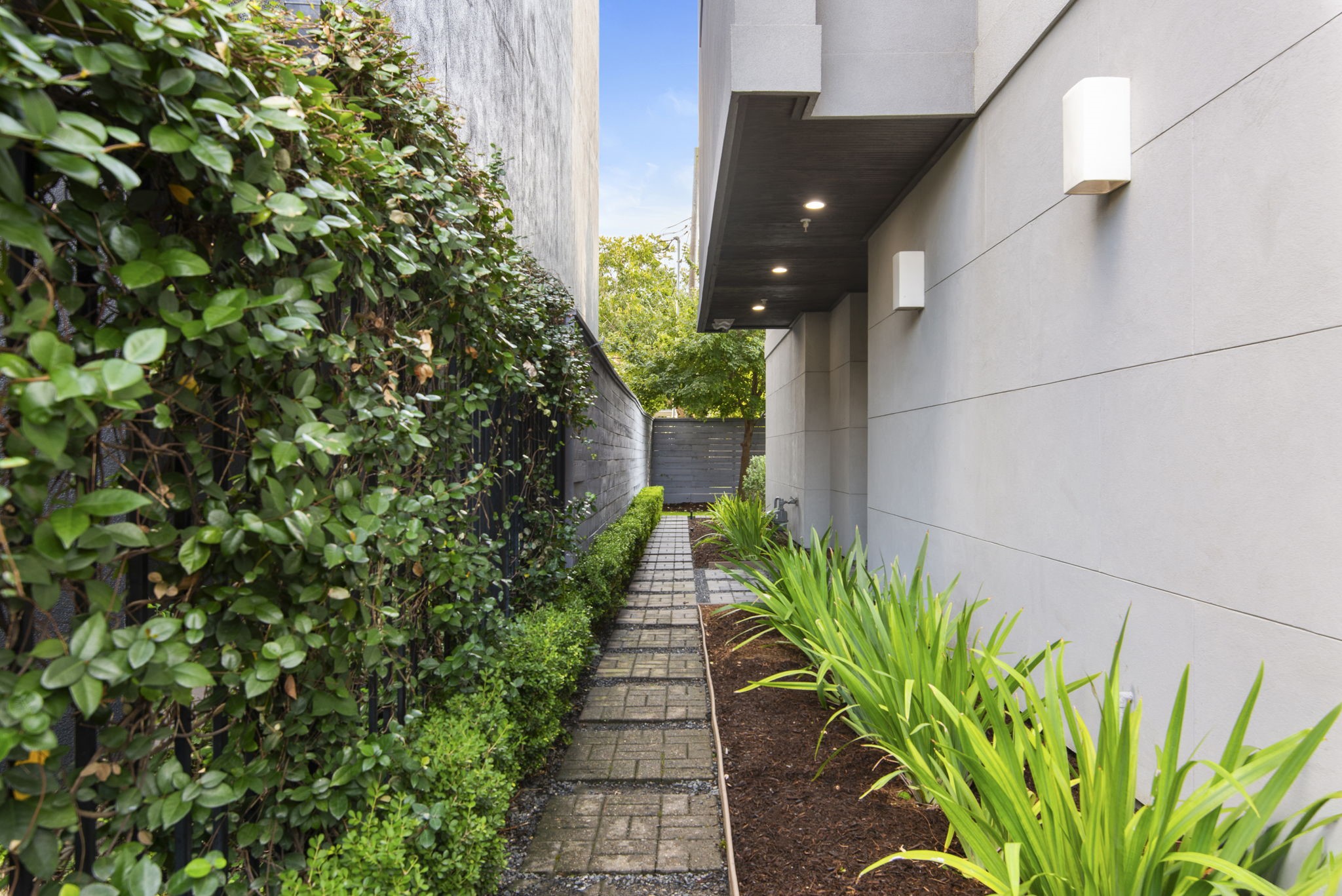 205 Portland Street Houston, TX 77006 - Photo 5 of 36 a pathway of a house with a yard