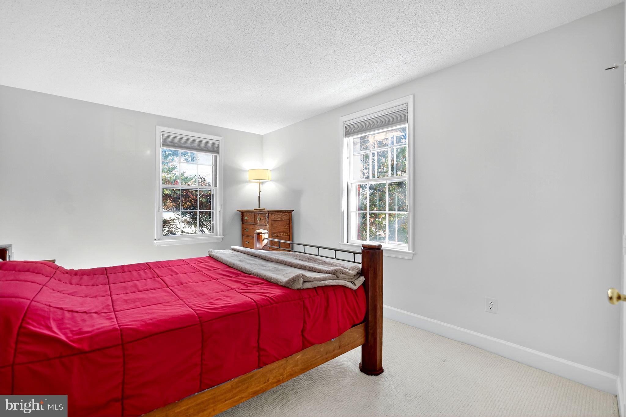 500 Bashford Lane, Unit 3321 Alexandria, VA 22314 - Photo 11 of 20 a bedroom with a bed and window