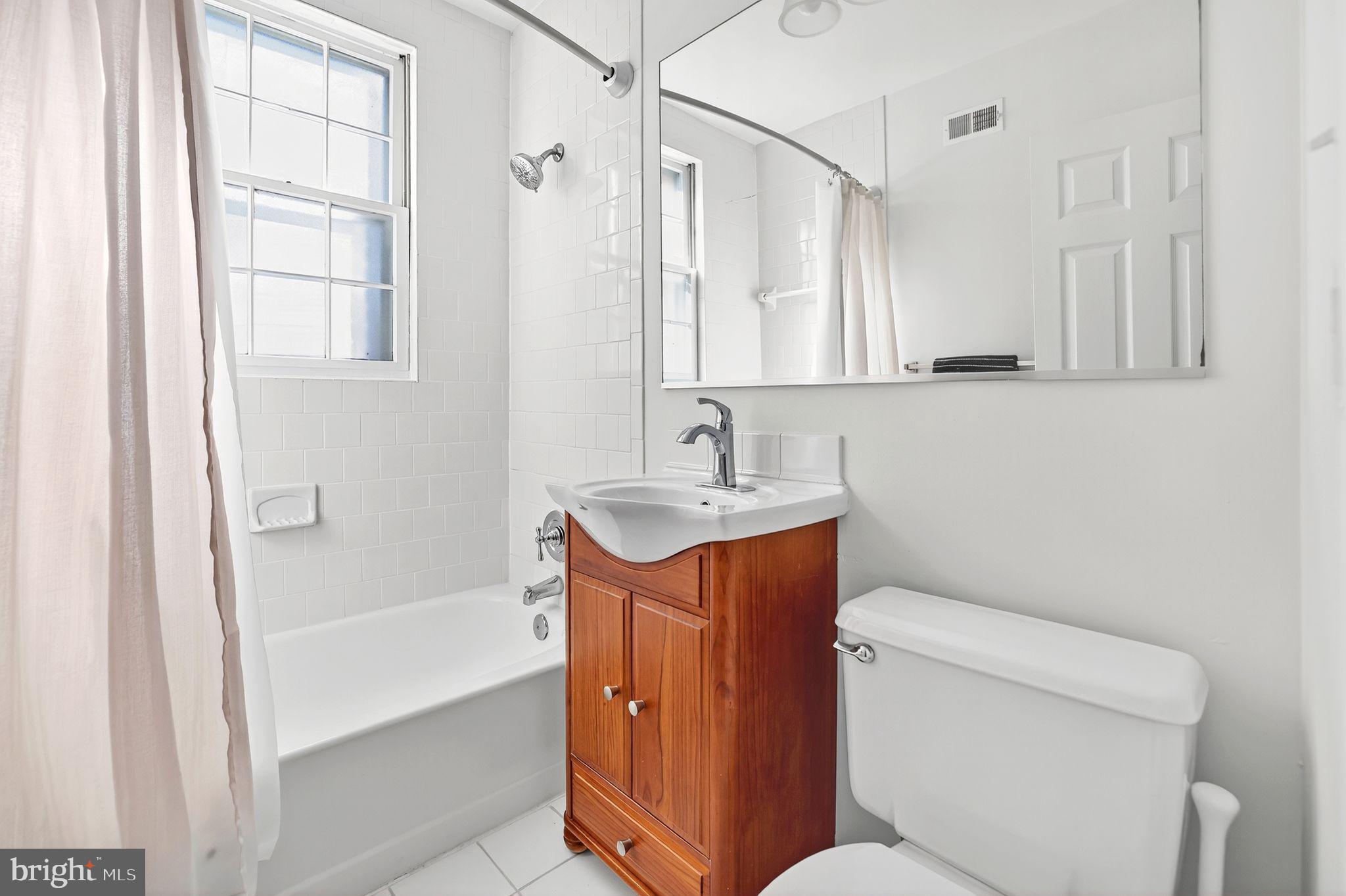 500 Bashford Lane, Unit 3321 Alexandria, VA 22314 - Photo 12 of 20 a bathroom with a granite countertop sink toilet and shower