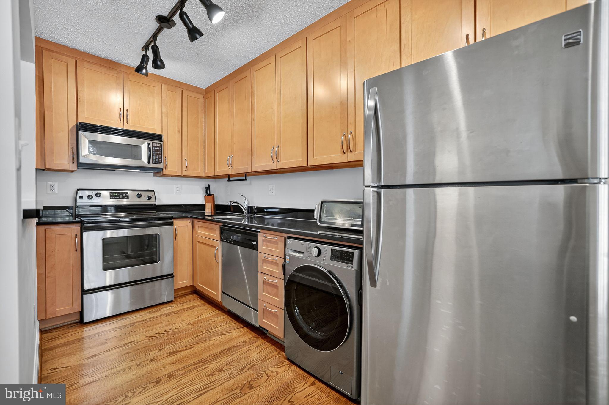 500 Bashford Lane, Unit 3321 Alexandria, VA 22314 - Photo 2 of 20 a kitchen with stainless steel appliances granite countertop a refrigerator a stove top oven a sink and dishwasher