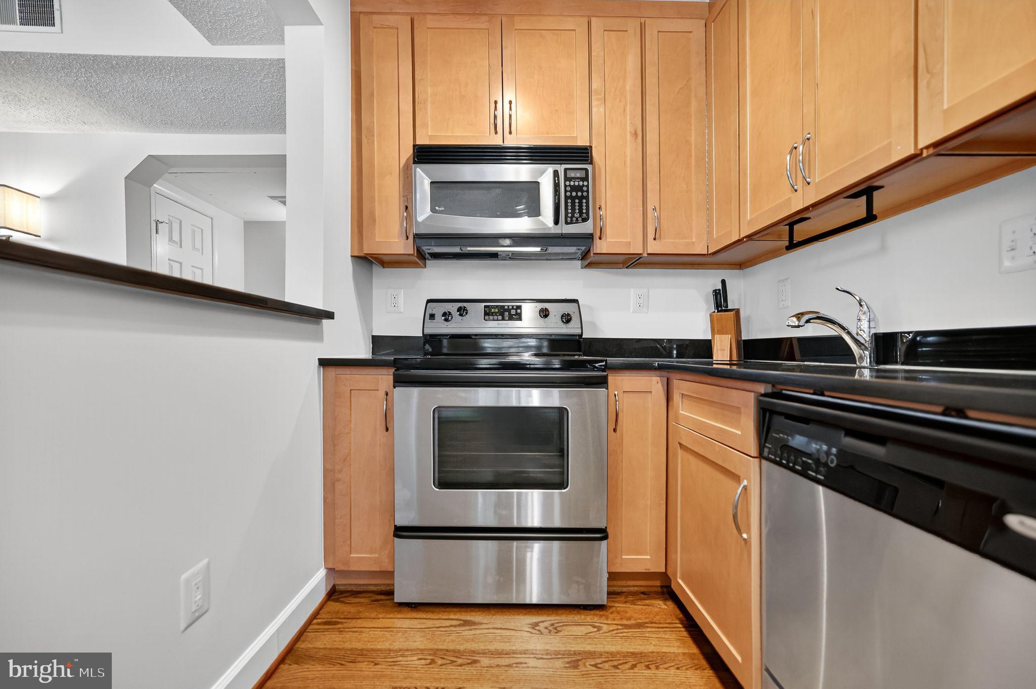 500 Bashford Lane, Unit 3321 Alexandria, VA 22314 - Photo 3 of 20 a kitchen with stainless steel appliances a stove a microwave a sink and cabinets