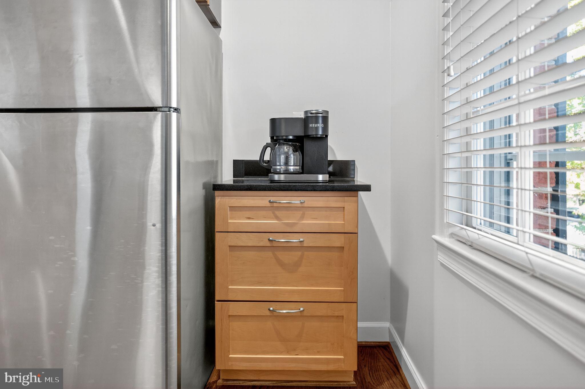 500 Bashford Lane, Unit 3321 Alexandria, VA 22314 - Photo 4 of 20 a view of a kitchen with refrigerator and wooden floor