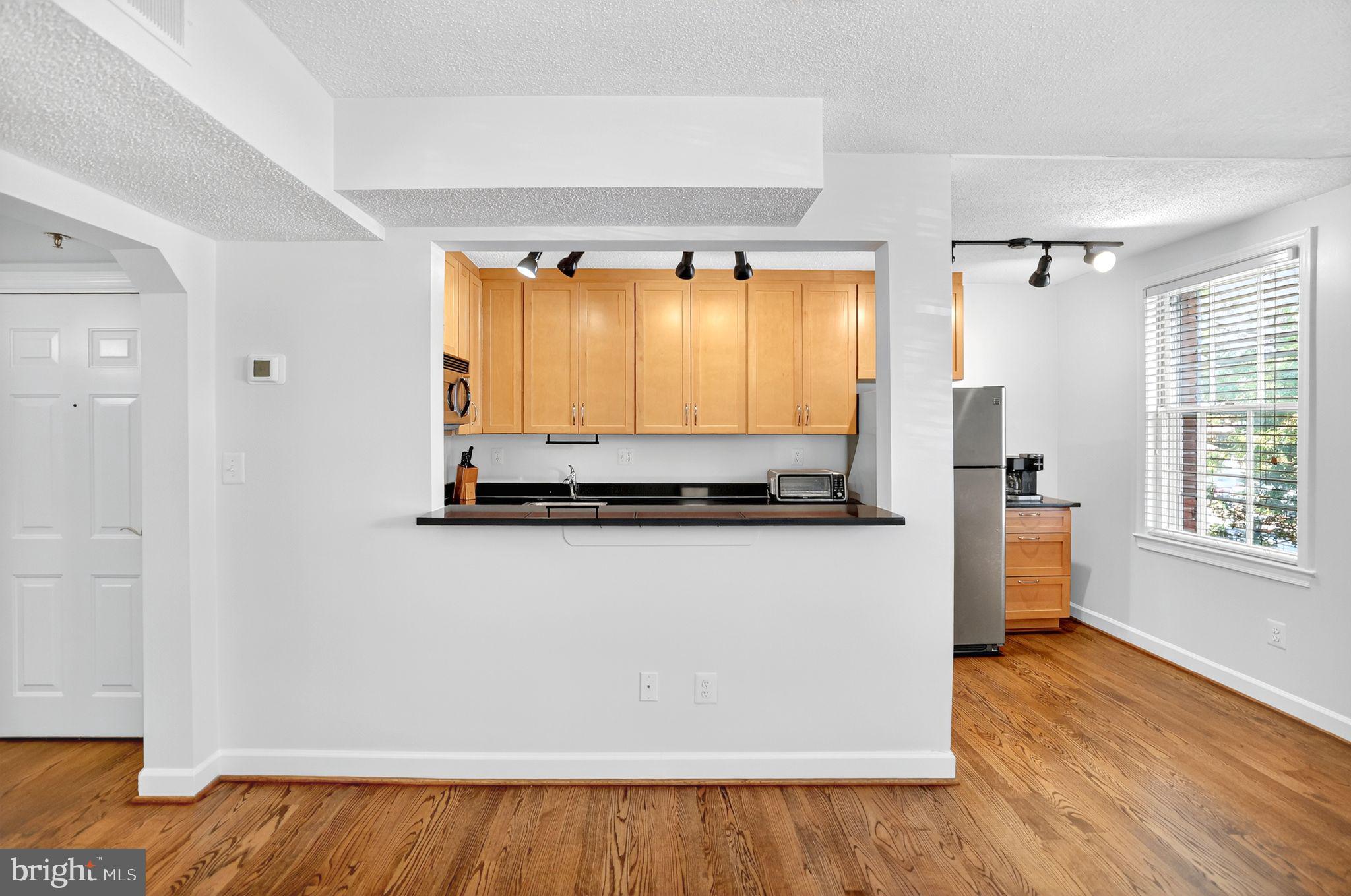 500 Bashford Lane, Unit 3321 Alexandria, VA 22314 - Photo 5 of 20 a living room with wooden floor and a window