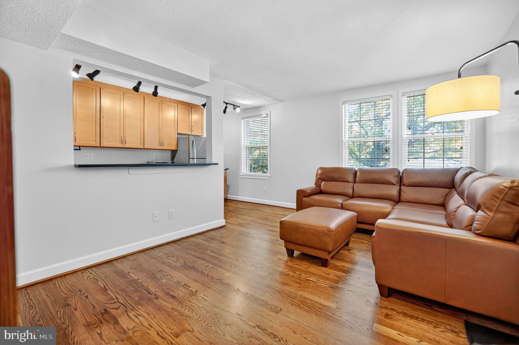 500 Bashford Lane, Unit 3321 Alexandria, VA 22314 - Photo 8 of 20 a living room with furniture and a flat screen tv
