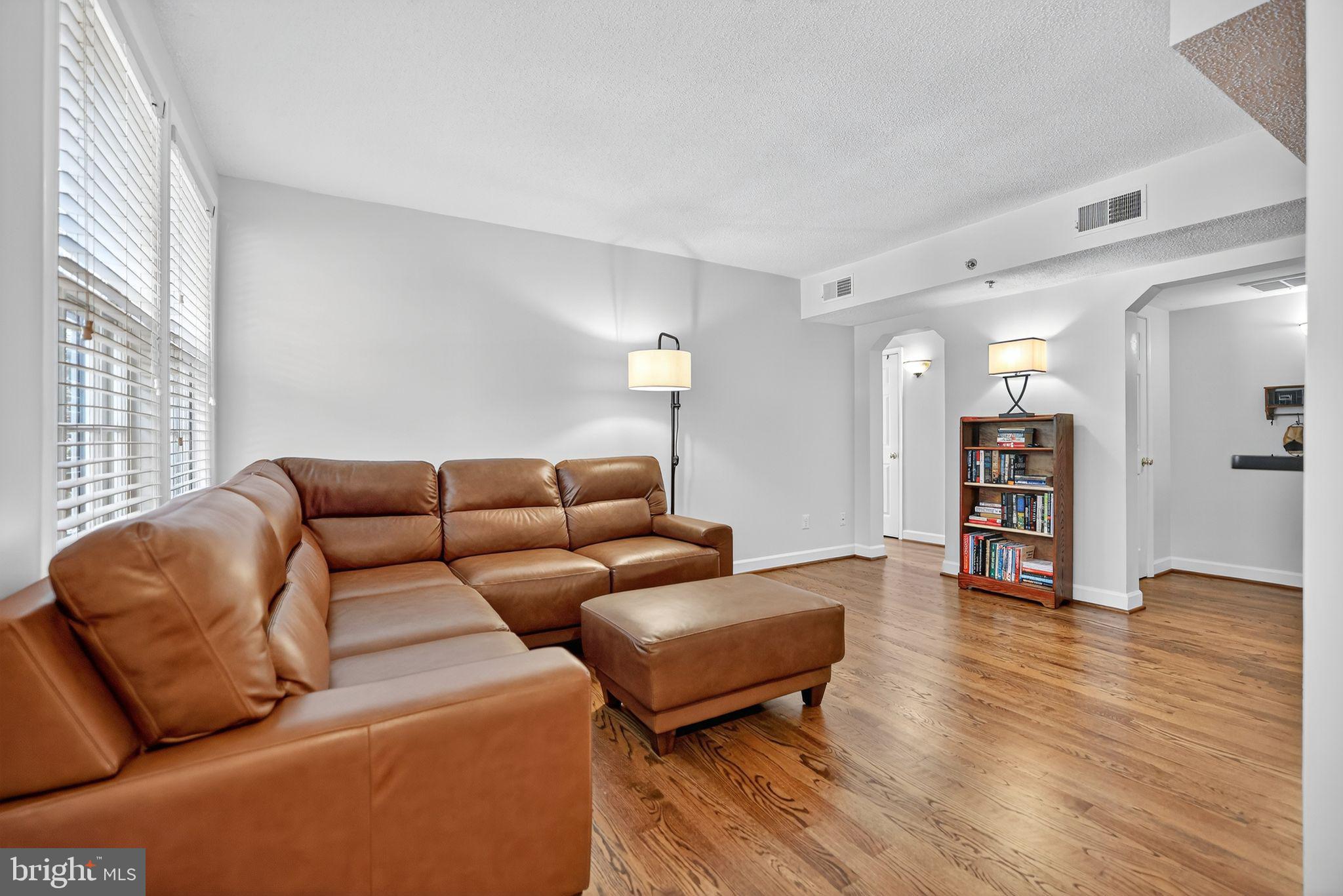500 Bashford Lane, Unit 3321 Alexandria, VA 22314 - Photo 9 of 20 a living room with furniture and wooden floor