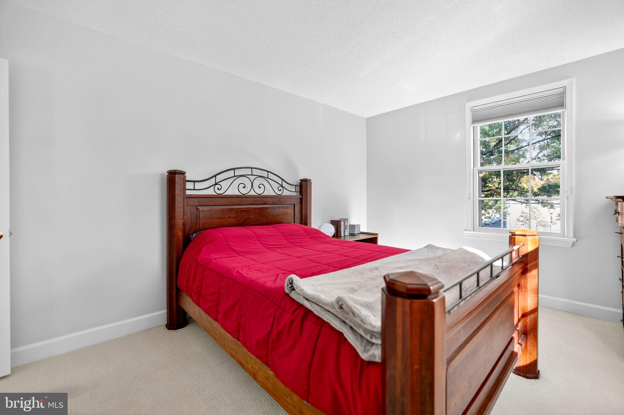 500 Bashford Lane, Unit 3321 Alexandria, VA 22314 - Photo 10 of 20 a bedroom with a bed and a window