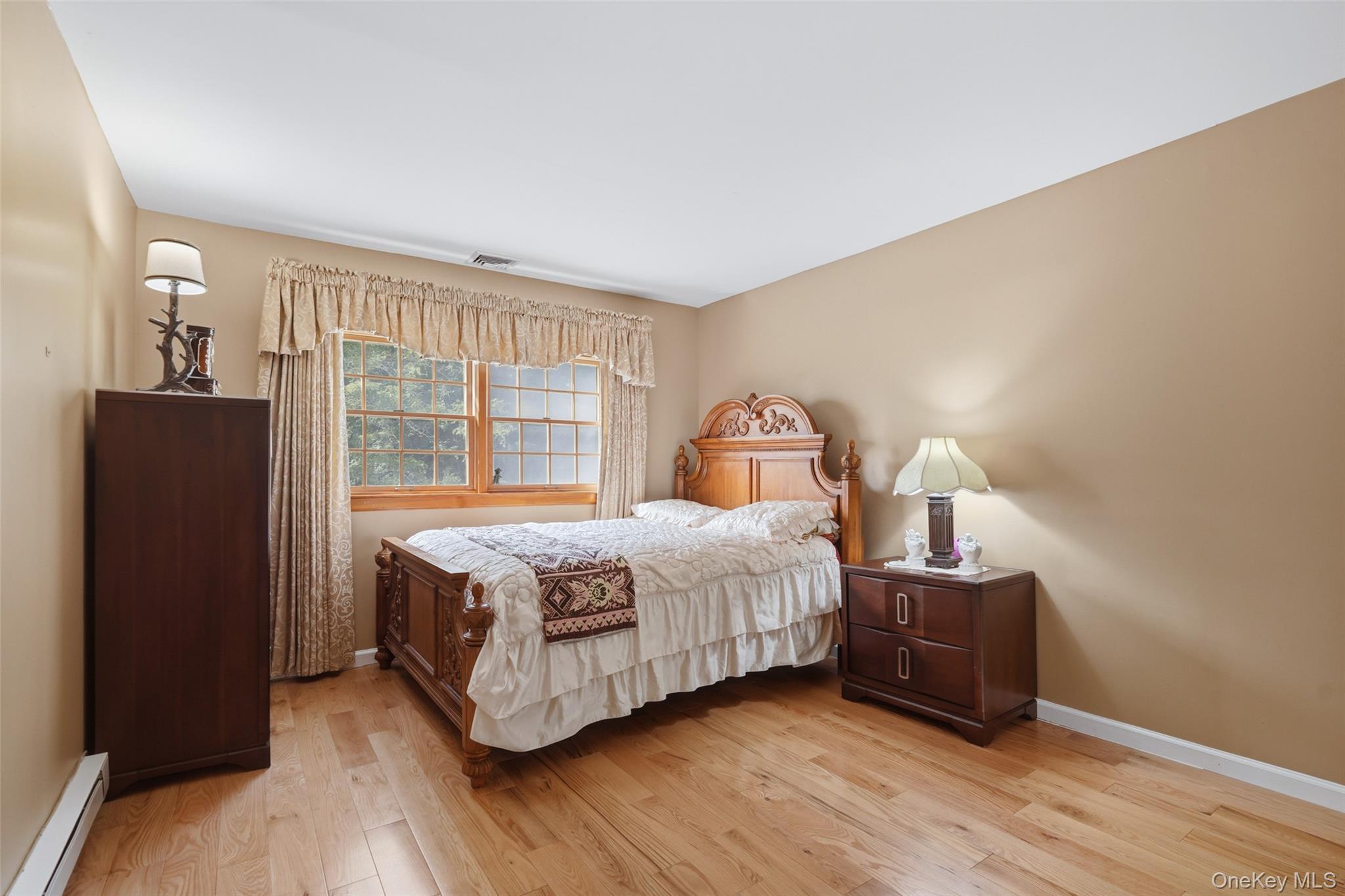 623 Cardinal Road Cortlandt Manor, NY 10567 - Photo 23 of 40 a bedroom with a bed and wooden floor