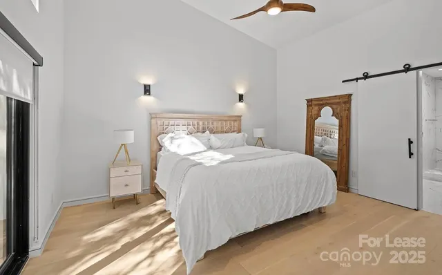 a bedroom with a bed and a lamp