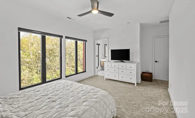 a view of a livingroom with furniture and a flat screen tv
