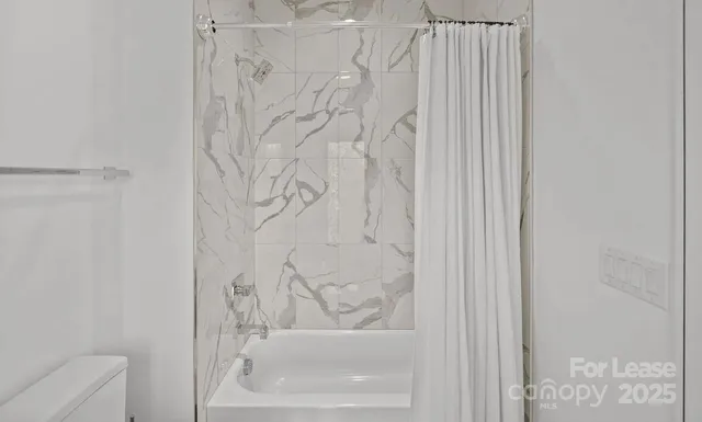 a bathroom with a bathtub and shower