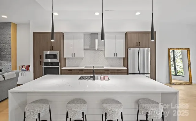 a kitchen with stainless steel appliances a sink and a refrigerator