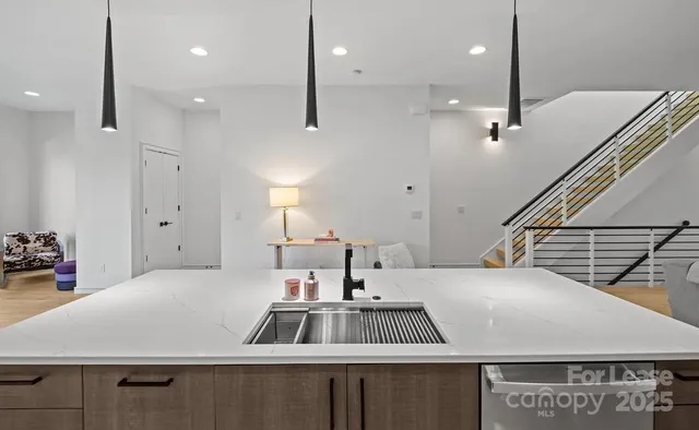 a kitchen with kitchen island a sink appliances and a counter top space