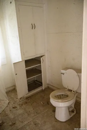 a white toilet sitting next to a sink