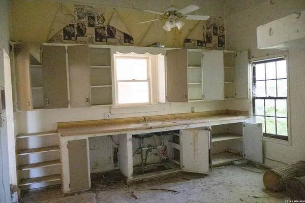 a room with a window and cabinets